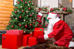 Santa putting gifts under the tree
